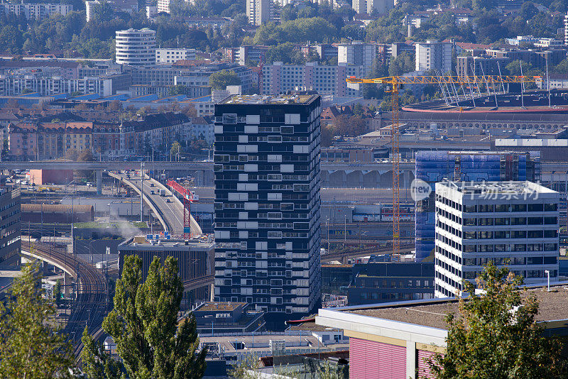 Aerial view of City of Zürich with skyscrapers and urban roads on a sunny late summer day.